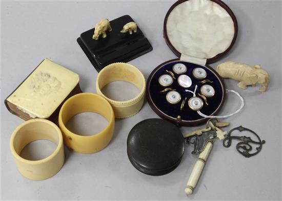 A cased gilt and mother-of-pearl dress set, an ivory-mounted miniature hymn book, a bakelite fire lighter, ivory elephants and sundries